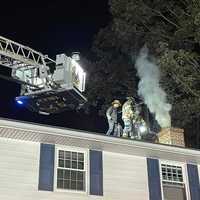 <p>Crews on the roof fighting the chimney fire.</p>