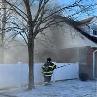 <p>Fire fighters at the scene of the fatal house fire.</p>