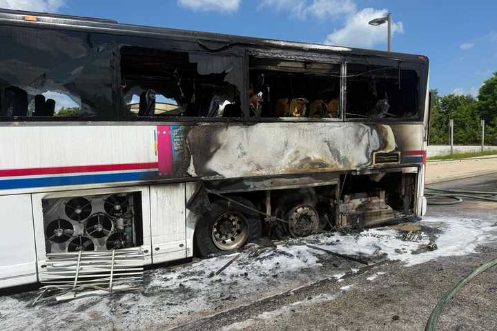 Tour Bus Erupts In Flames At Maryland Park-And-Ride, Sending One To Hospital: Officials