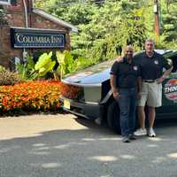 <p>Fabio Antonio Arbelaez and Ryan McDermott with a Tesla Cybertruck outside of The Columbia Inn.&nbsp; &nbsp; &nbsp;</p>