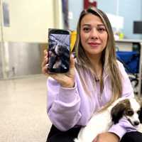 <p>Natalie D'Angelo holds Stella at the Bergen County Animal Shelter, and a photo of her dog Zoey, who passed away in March.</p>