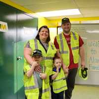 <p>Alan poses next to his big brother Theo, 7, and their parents, Lola and Luke.&nbsp;</p>