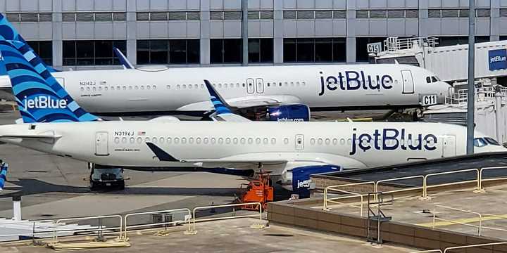 Two JetBlue planes parked at&nbsp;Boston Logan International Airport