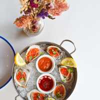 <p>Oysters with roe and a sampling of sauces.&nbsp;</p>