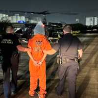 <p>Louisiana State Police guide a hooded Kendall Myles to a chopper to return him to a prison facility after he escaped a New Orleans prison with nine others. His head was covered because he became violent during his capture, police said.&nbsp;</p>