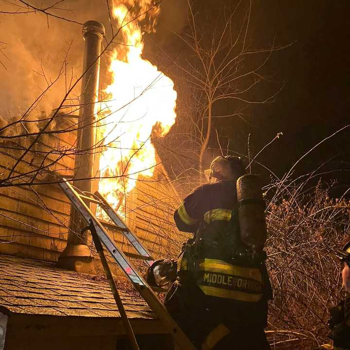 Middleborough firefighters battle a blaze at a Locust Street home on Monday night, Dec. 2. A man pulled from the fire day of his wounds days later. 