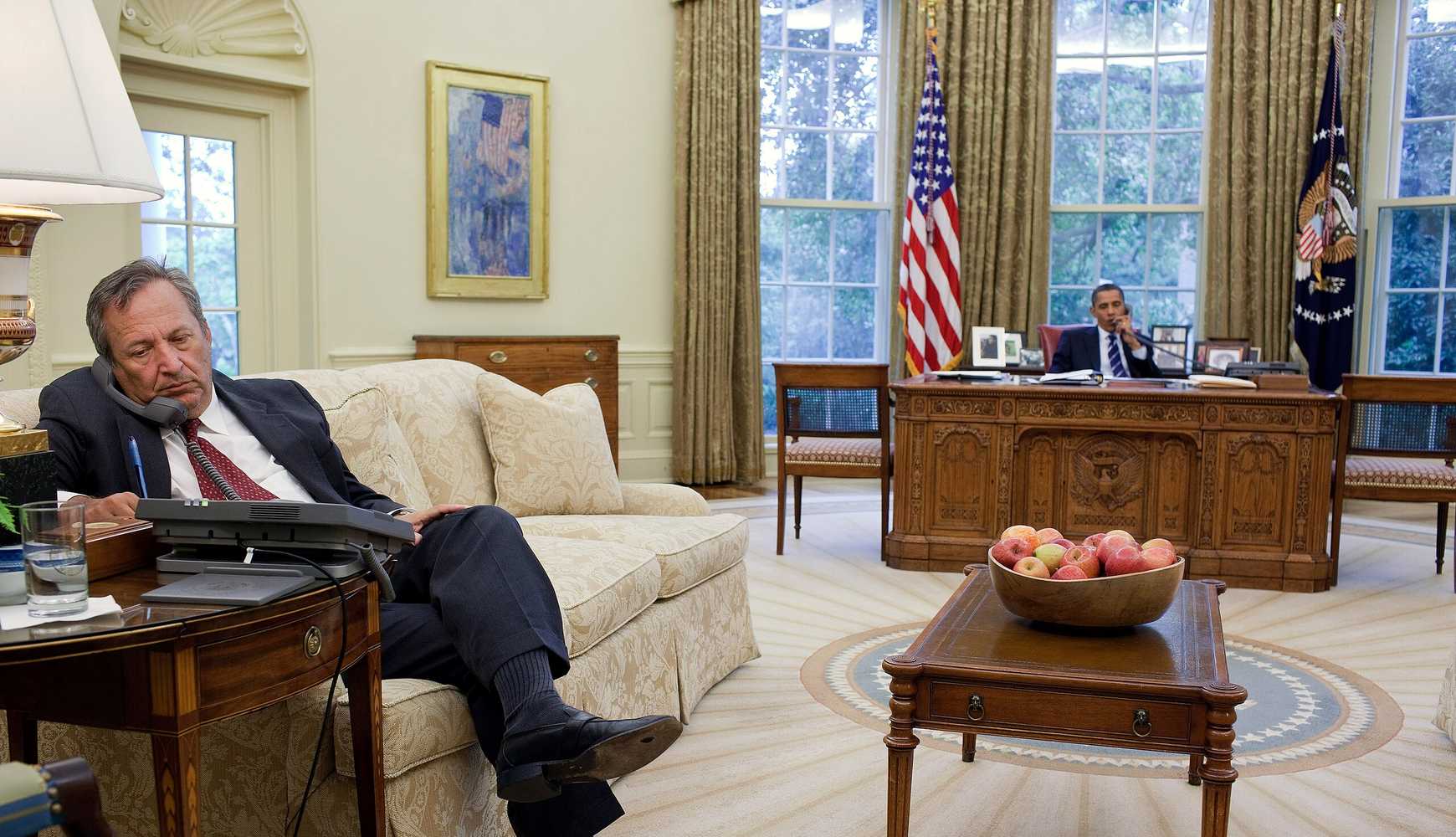 
President Barack Obama talks on the phone while National Economic Council director Larry Summers listens to the call in August 2010.
