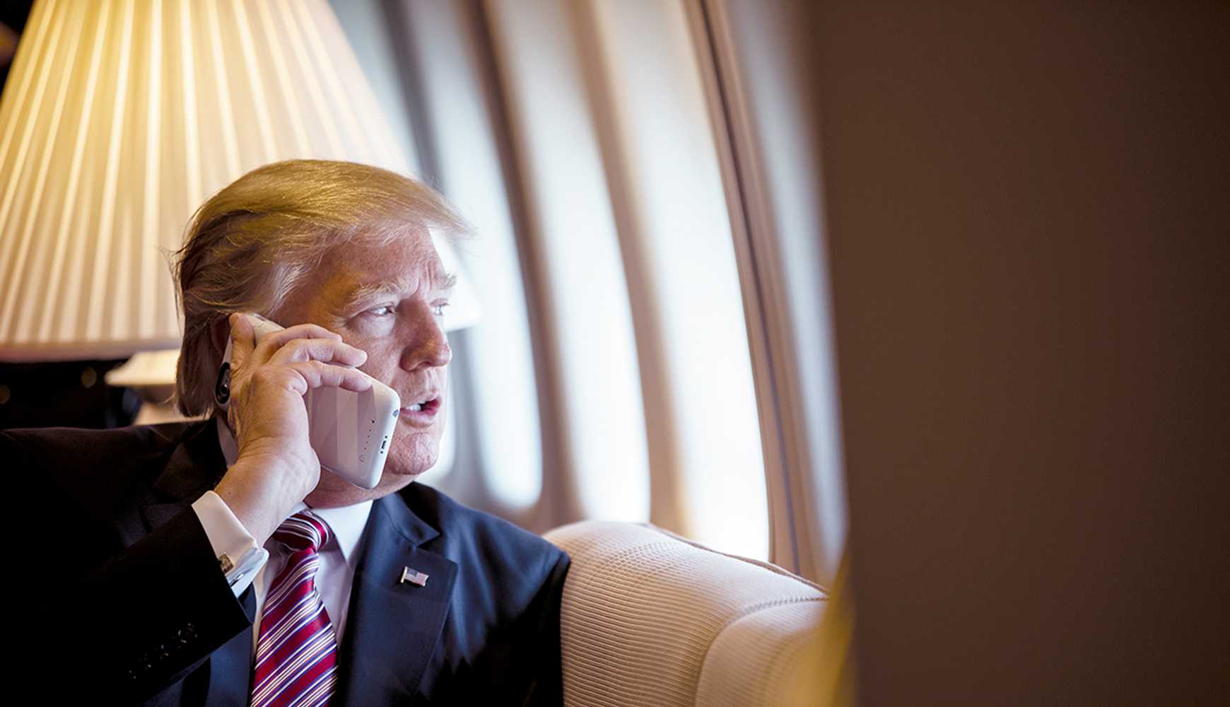 
President Donald Trump talking on a smartphone aboard Air Force One on January 26, 2017.
