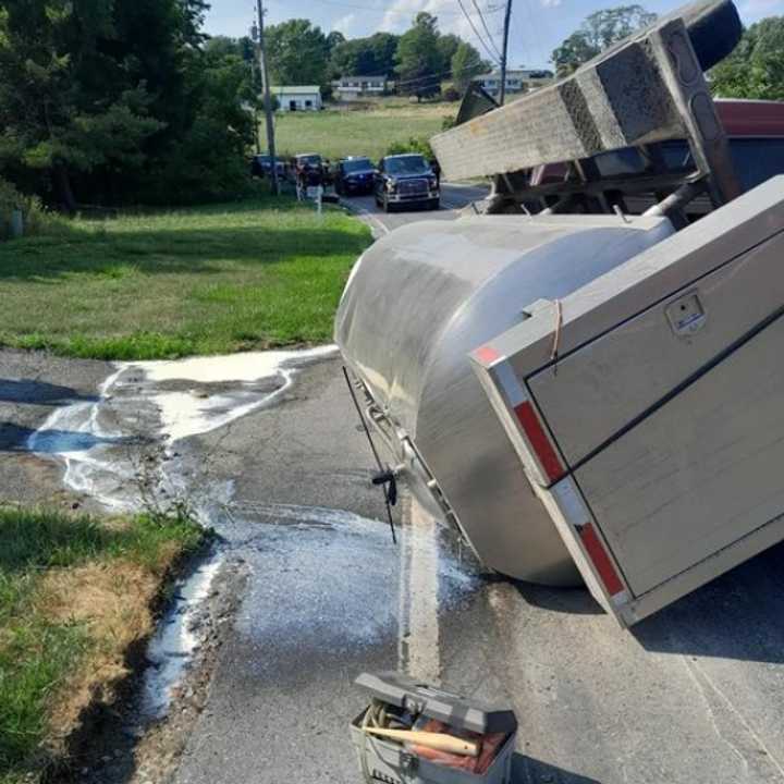 The scene of the overturned tanker truck spilling milk onto the road in Quarryville.