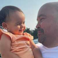 <p>Luis Santiago and his grandchild.</p>