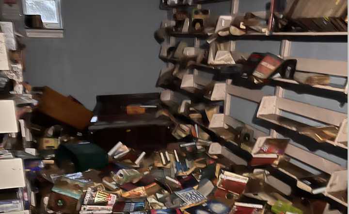 Books are strewn across the floor at The Smithtown Library One North Country Road in Smithtown following heavy flooding on Monday, Aug. 19.
  
