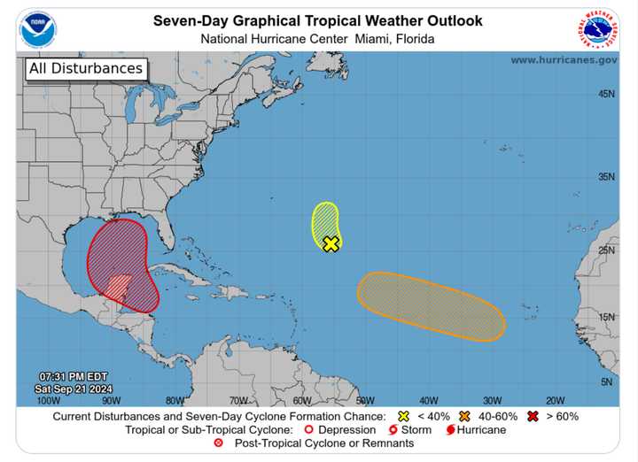 A system in the Gulf of Mexico (outlined in red) could become a hurricane by the end of this week. Forecasters are also watching another system in the Caribbean (marked with a yellow X).