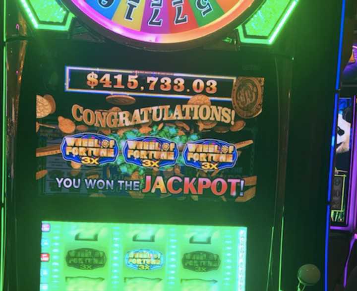 The lucky winner's slot machine displays the $415,733 jackpot.