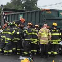 <p>The vehicle appears to have been wedged under the construction vehicle.</p>