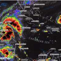 <p>An enhanced satellite image by AccuWeather on Saturday morning, Oct. 19, shows Nadine (far left) around the time it became a tropical storm.</p>