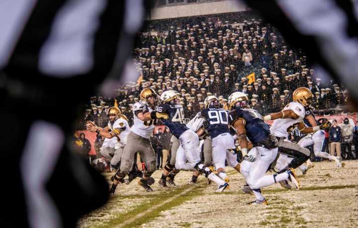 U.S. soldiers and sailors play in the 2013 Army-Navy football game in Philadelphia Dec. 14, 2013.