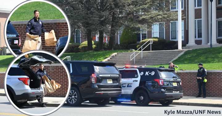 Authorities remove evidence bags (left) at Fort Lee High School where a student was stabbed Tuesday morning, April 8.