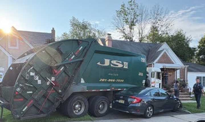 A runaway garbage truck struck three parked cars and slammed into a home in New Milford after the driver stepped out to collect trash Tuesday morning, July 8, police said.