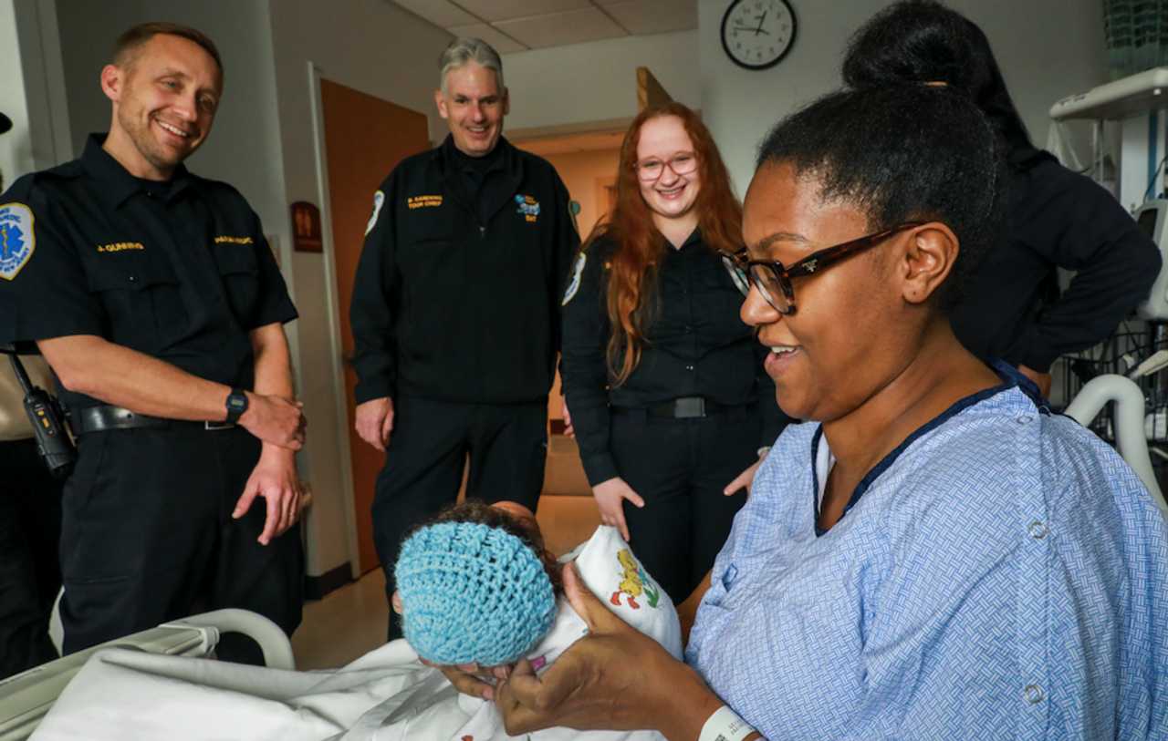 Avante Nicolls shows the Holy Name EMT squad Baby Hendrix after they helped deliver hiim. Avante Nicolls shows the Holy Name EMT squad Baby Hendrix after they helped deliver hiim.