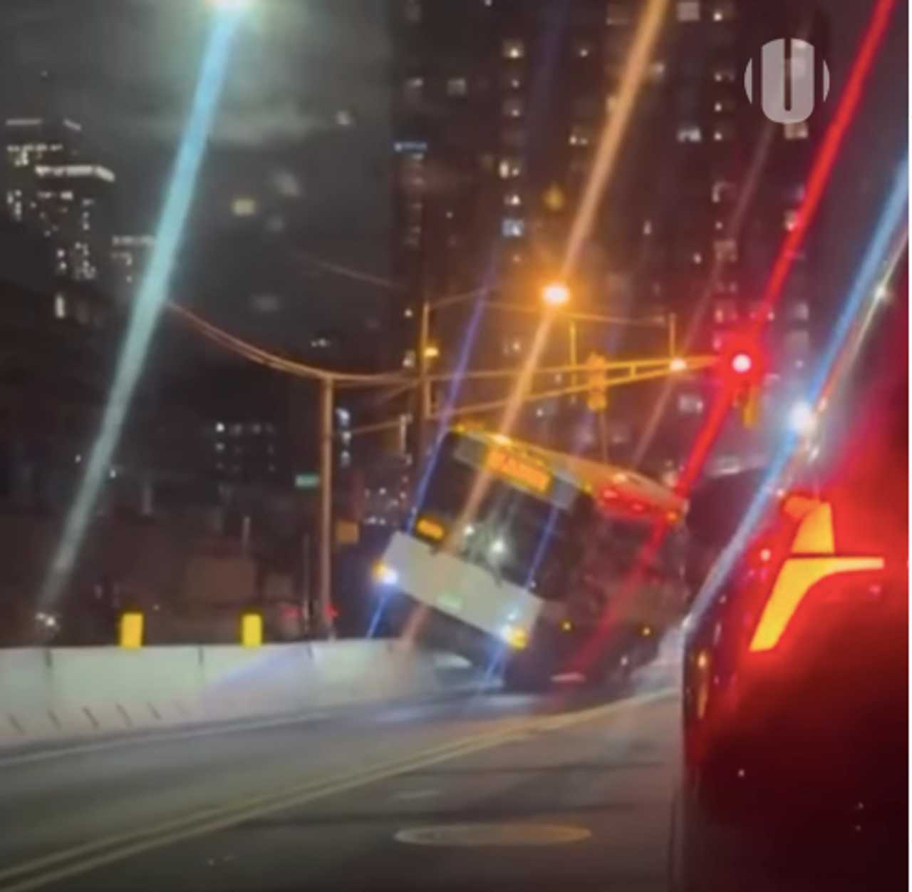 NJ Transit bus mounts barrier. NJ Transit bus mounts barrier.