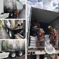 <p>Firefighters at the scene of the tractor-trailer fire.</p>