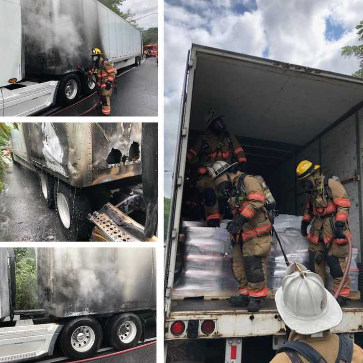 Firefighters at the scene of the tractor-trailer fire.