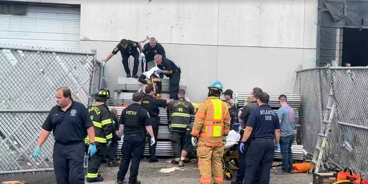 First responders helped rescue a man who fell from a roof and got trapped between pipes.