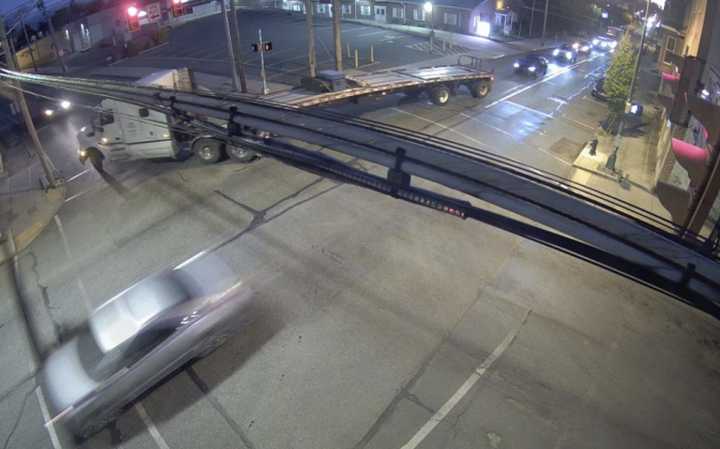 The vehicle fleeing after striking a pedestrian crossing sign. 