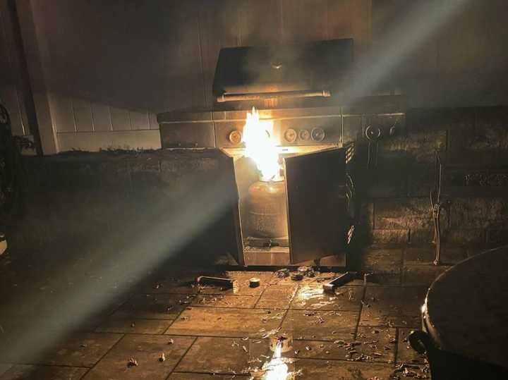 A propane tank inside an outdoor grill started the fire. 