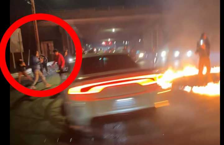 Seconds after this screenshot, a Dodge Charger crashes into the two men circled during a street takeover early Saturday morning, Dec. 28, in North Haven.&nbsp;