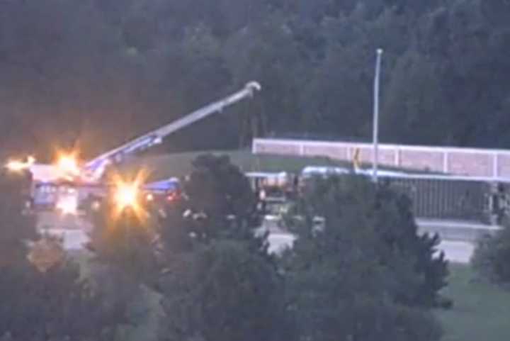 A crane is lifting up the tractor-trailer after it rolled over, spilling dog food, on the Pennsylvania Turnpike/Interstate 76, officials say.