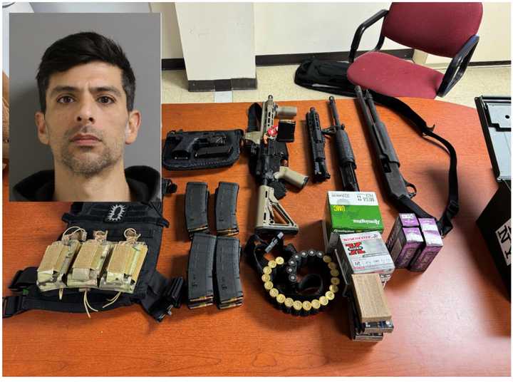 Brian Negrette and the guns seized during the raid.&nbsp;