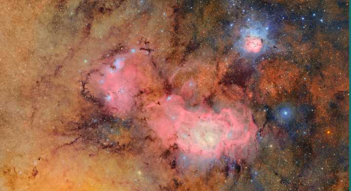 This image combines 678 images taken in hours. Combining many images reveals clouds of gas and dust that comprise the Trifid Nebula (top) and the Lagoon Nebula, which are several thousand light-years away from Earth.&nbsp;