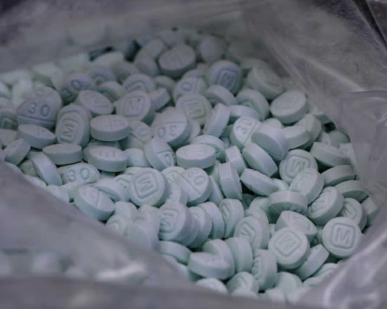 Fentanyl pills in a bag marked with an "M". Fentanyl pills in a bag marked with an "M".