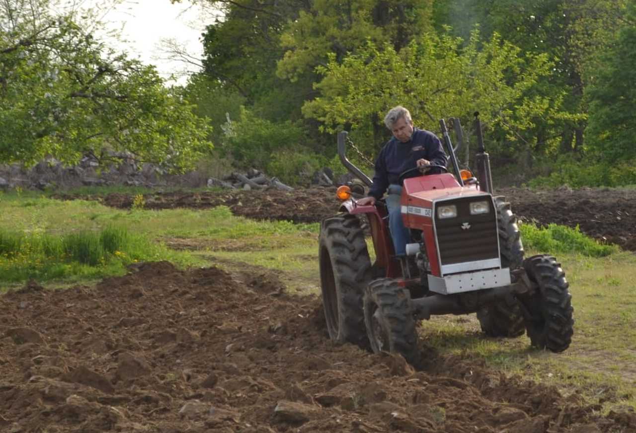 John Augustin, in 2016, tends to his crops despite having lost a leg 10 years earlier in a tractor accident. The lifelong farmer persevered and relearned to walk and farm. He died the day before Thanksgiving after a sudden fall, his loved ones said. John Augustin, in 2016, tends to his crops despite having lost a leg 10 years earlier in a tractor accident. The lifelong farmer persevered and relearned to walk and farm. He died the day before Thanksgiving after a sudden fall, his loved ones said. 