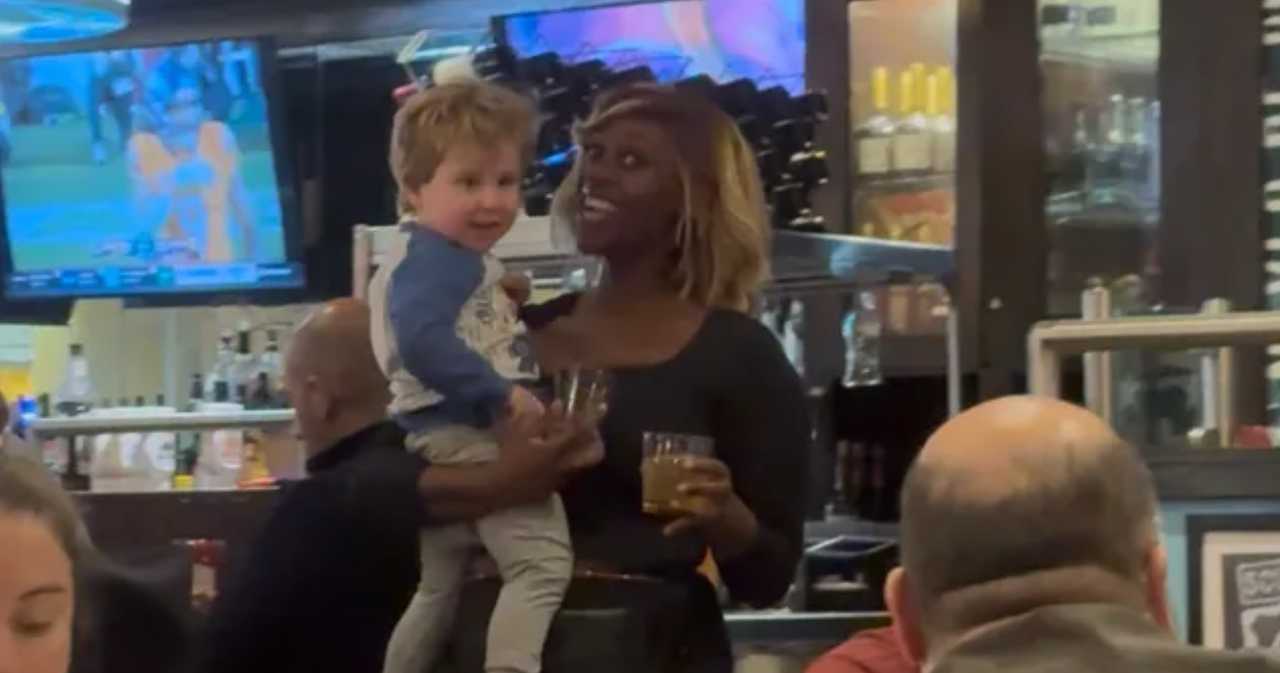 Brittany Bell, a waitress at a TGI Friday's at an Atlanta airport, dances around the restaurant with a Connecticut family's toddler. The family has created a GoFundMe to thank her for that small kindness. 