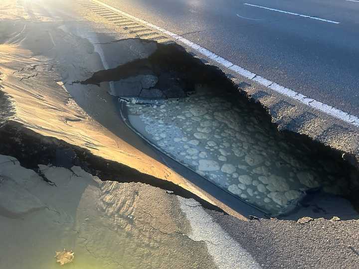 Police are warning drivers to expect major delays on I-495 in the Methuen-Haverhill corridor after a water main burst created this sinkhole.&nbsp;