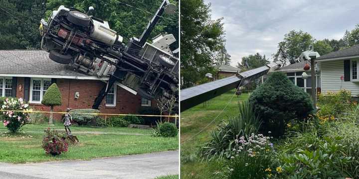 A crane fell onto a house in the North Greenbush hamlet of Defreestville on Monday, July 29.