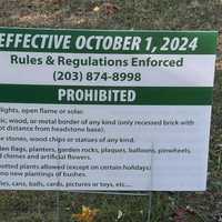 <p>A sign stating the new rules for gravesite offerings at&nbsp;King’s Highway Cemetery in Milford.</p>