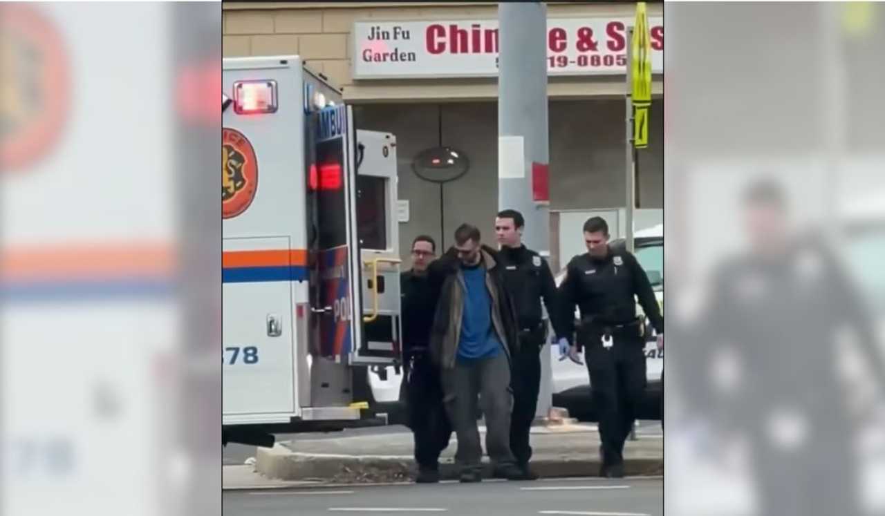 Nassau County Police escort a suspect into an ambulance following a double stabbing at A &amp; A Italian Deli in Bethpage on Thursday morning, Dec. 4.
  
