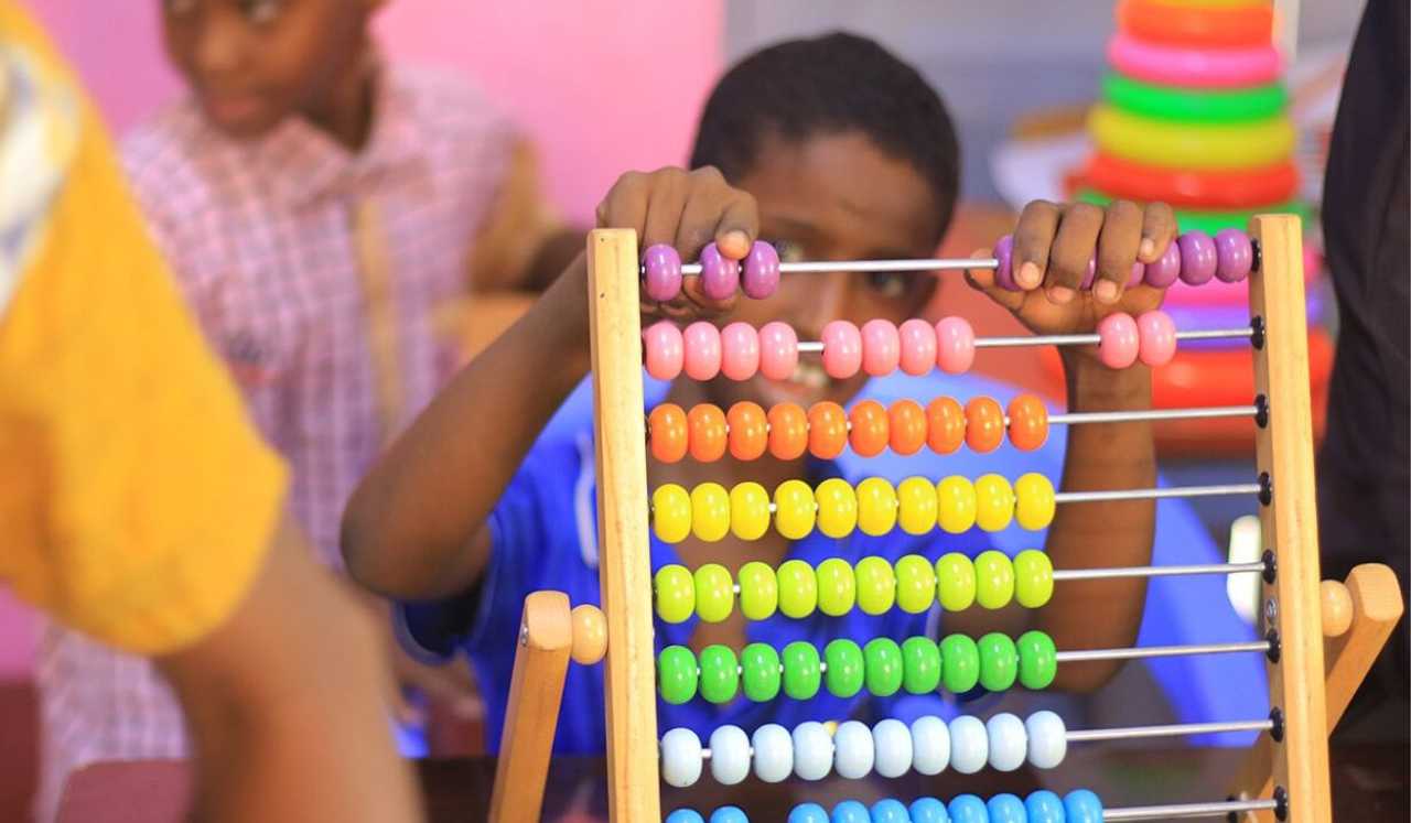 A child plays with a slide toy at a school in Somalia.