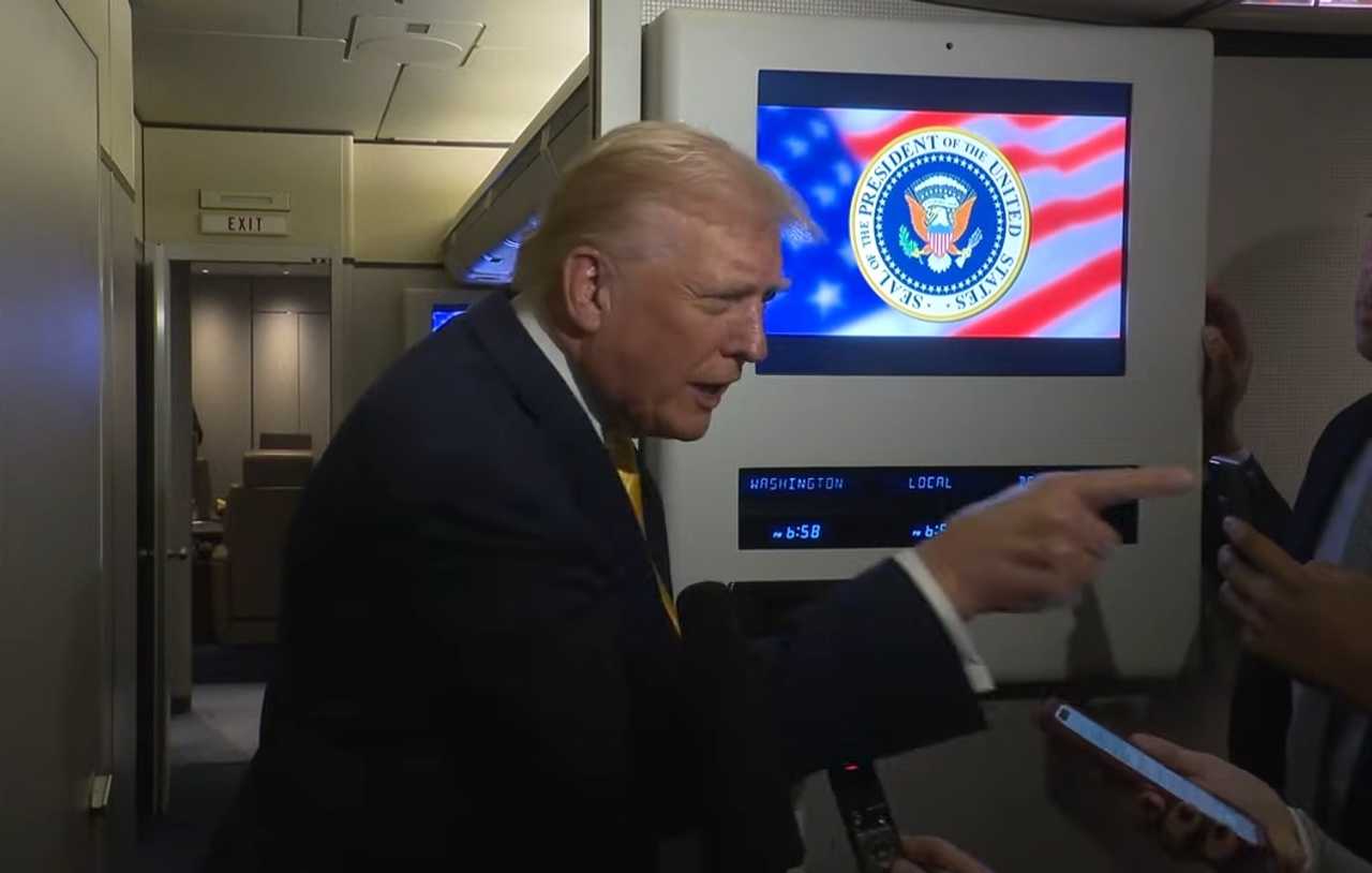 President Donald Trump points at a female reporter while saying "Quiet, piggy" aboard Air Force One on November 14, 2025.