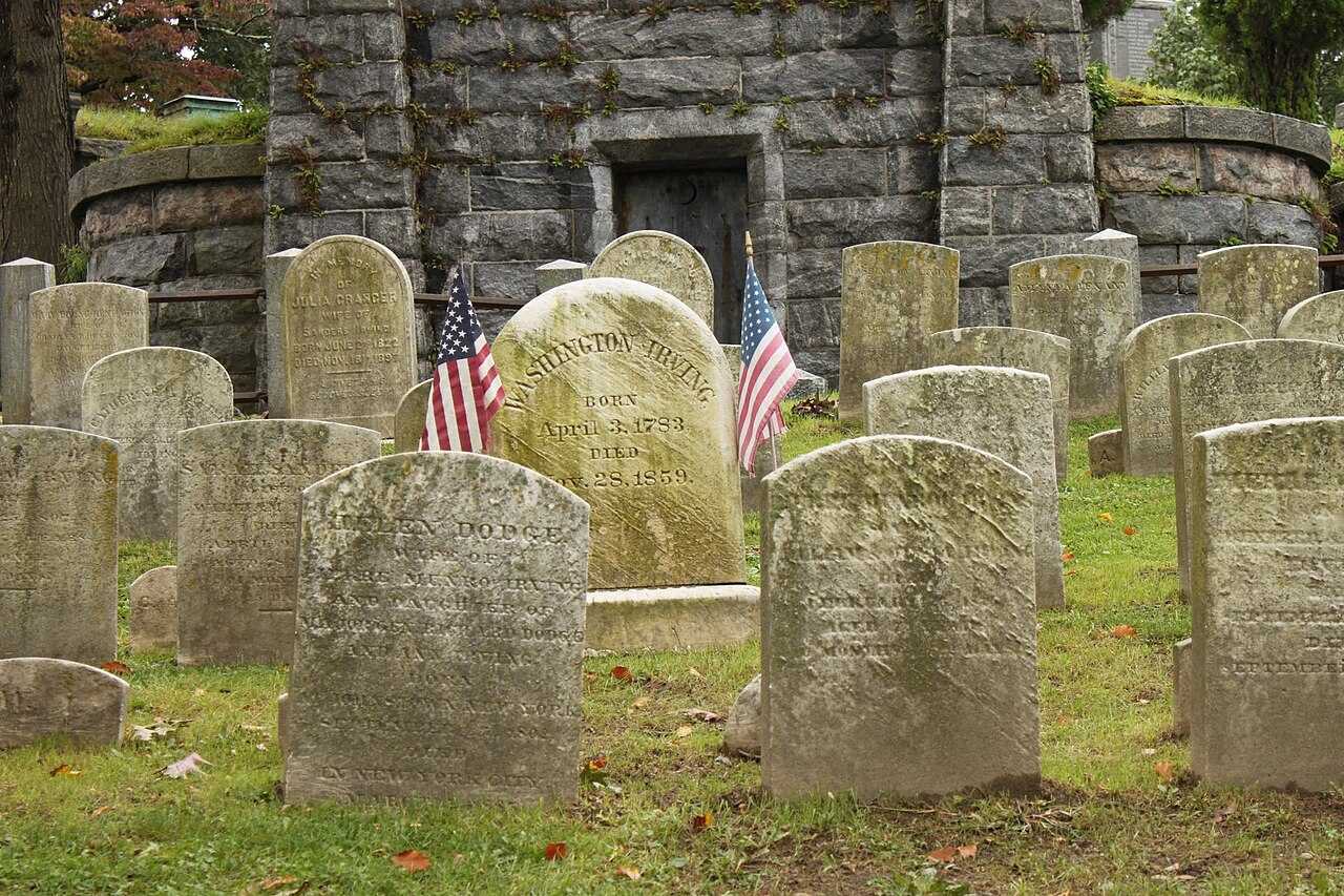 Sleepy Hollow Cemetery in Sleepy Hollow, NY. The gravestone for 19th-century writer Washington Irving is surrounded by two US flags. Sleepy Hollow Cemetery in Sleepy Hollow, NY. The gravestone for 19th-century writer Washington Irving is surrounded by two US flags.