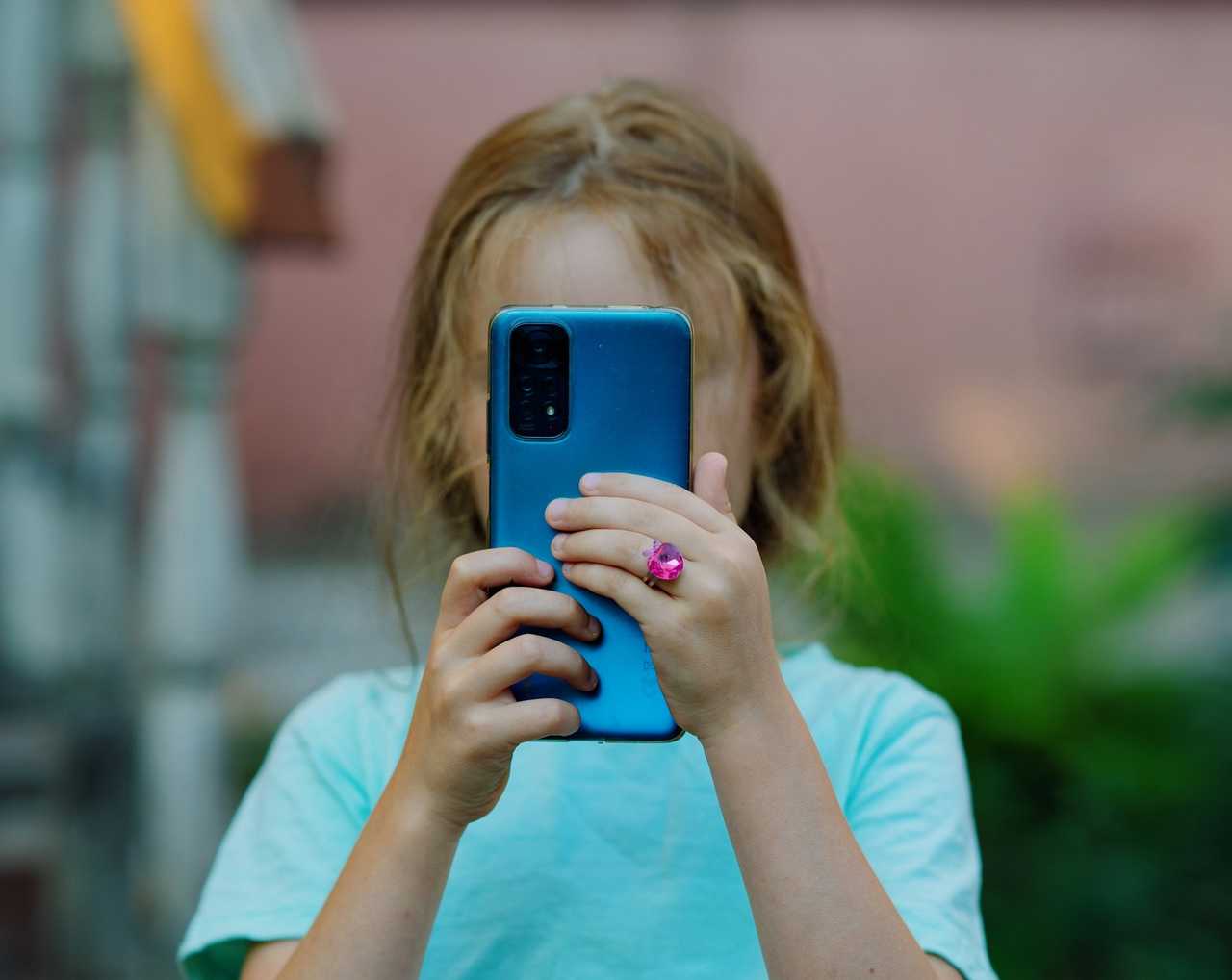 A girl using a smartphone.