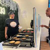 <p>Amal helps a customer at Kukki Vegan.</p>