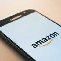 <p>Amazon's logo displayed on a smartphone screen.</p>