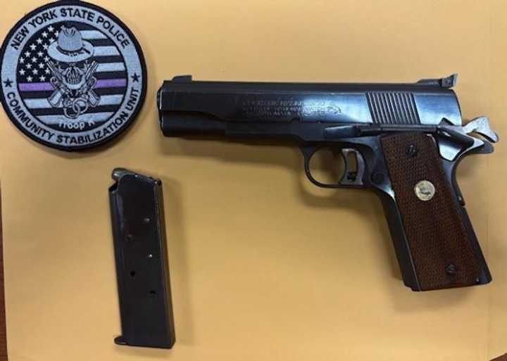 Troopers found this loaded Colt MK IV Series 70 semi-automatic handgun in the car, police said. 