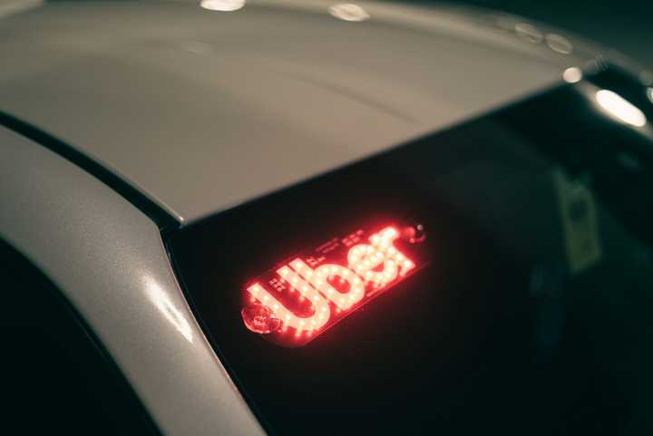 An Uber light on a car's windshield.