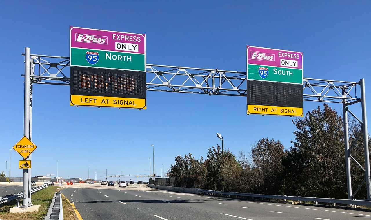 Signs for E-ZPass lanes on the Franconia-Springfield Parkway near an exit for Interstate 95 in Springfield, VA.
  
