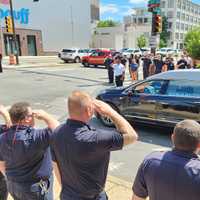 <p>PFD staff salute a hearse carrying late member Ka'Ron B. Montgomery. </p>